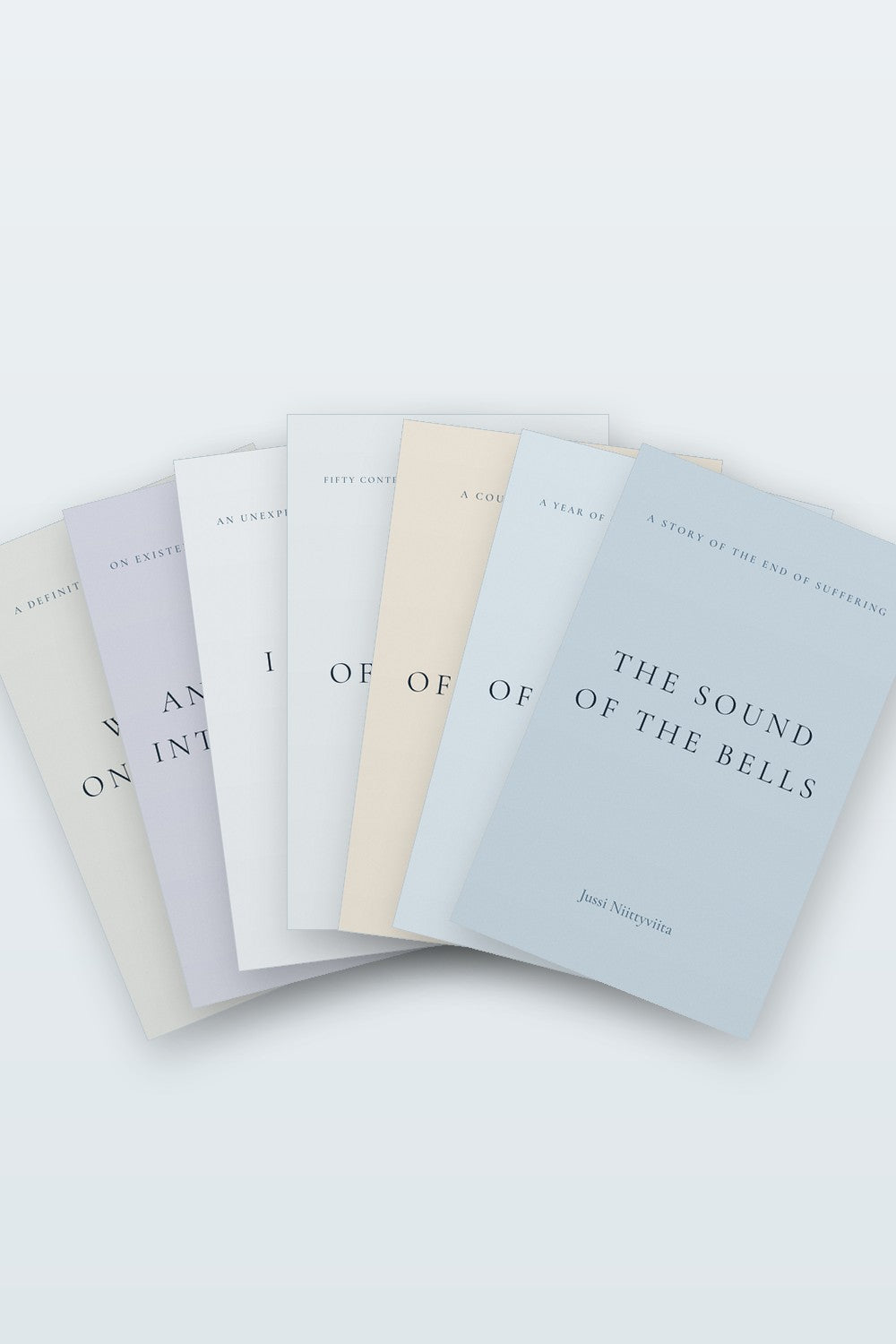 The seven books by Jussi Niittyviita, fanned out and seen from above